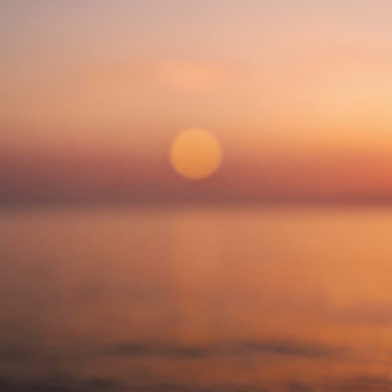 Album art for Low Sun, No Hurry: a soft sun setting over water